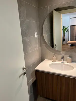 a bathroom with a sink and a mirror at BW Eterna Apartment in Sajmište