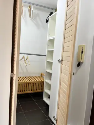 a closet with a white door and a tiled floor at Gajba Apartment in Belgrade