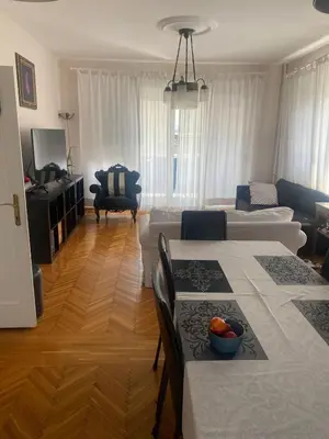 a living room with two tables and a couch at Apartman Lux in Belgrade