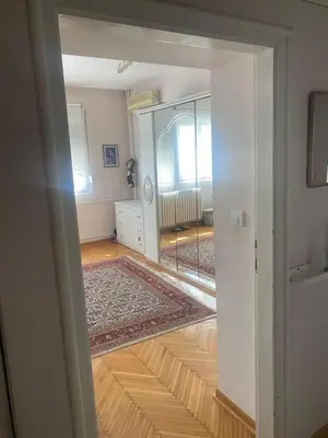 an open door to a living room with a mirror at Apartman Lux in Belgrade