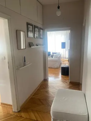a living room with a white couch and a table at Apartman Lux in Belgrade