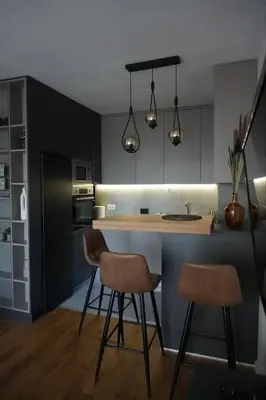 a kitchen with two bar stools and a counter with lights at Sunnyhome in Belgrade