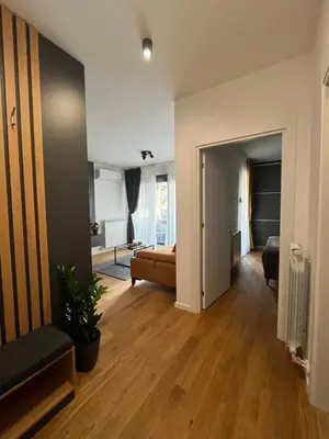 a living room with a couch and a bedroom at Sunnyhome in Belgrade