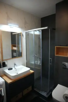 a bathroom with a sink and a glass shower at Sunnyhome in Belgrade