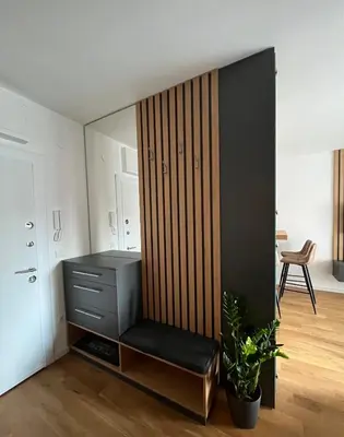 a room with a cabinet with a bench in it at Sunnyhome in Belgrade