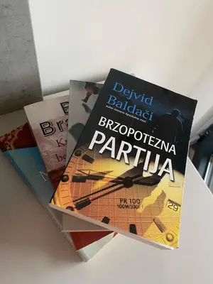three books sitting on top of a table at Forest View Apartment in Rogača