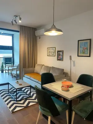 a living room with a couch and a table at Forest View Apartment in Rogača