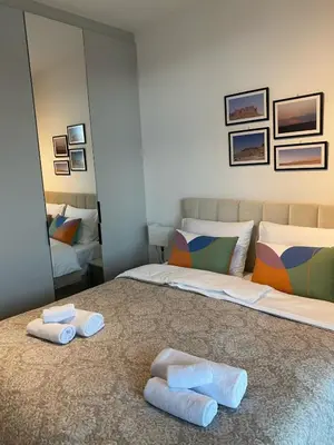 a bedroom with two beds with towels on the floor at Forest View Apartment in Rogača