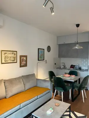 a living room with a couch and a table at Forest View Apartment in Rogača