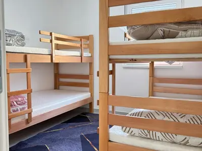 a room with bunk beds in a dorm room at Belgrade Airport Luxury Single in Surčin