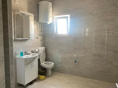 a bathroom with a toilet and a sink and a window at Belgrade Airport Luxury single bed in Surčin