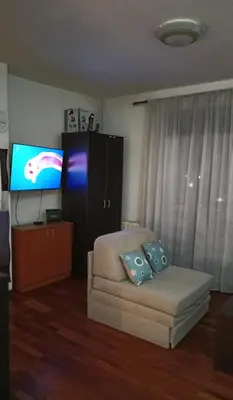 a living room with a couch and a flat screen tv at Ogi apartman in Belgrade