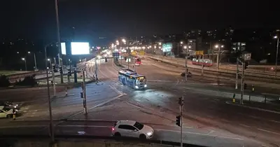 a bus driving down a city street at night at Ogi apartman in Belgrade