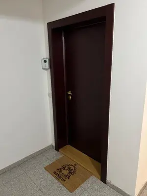 a black door with a mat in front of it at Mona Lux apartman in Arandjelovac
