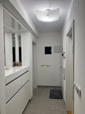 a white bathroom with a sink and a mirror at Mona Lux apartman in Arandjelovac