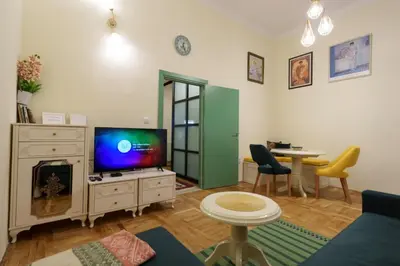 a living room with a tv and a table at Apartment Nedeljica in Belgrade