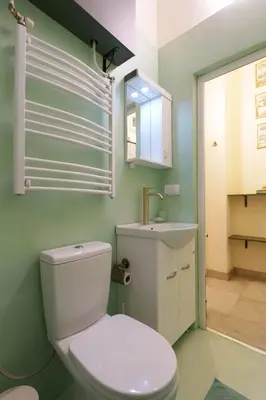 a bathroom with a white toilet and a sink at Apartment Nedeljica in Belgrade