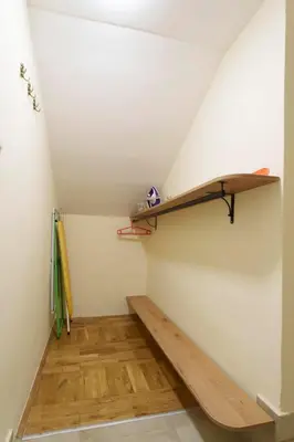 a room with a staircase with a wooden shelf at Apartment Nedeljica in Belgrade