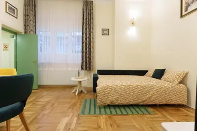 a living room with a bed and a window at Apartment Nedeljica in Belgrade