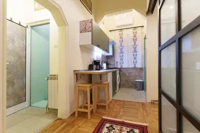 a small kitchen with a counter in a room at Apartment Nedeljica in Belgrade