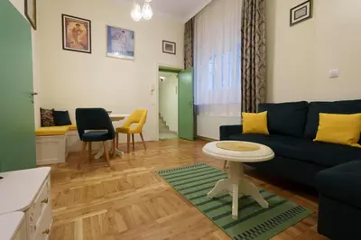 a living room with a blue couch and a table at Apartment Nedeljica in Belgrade