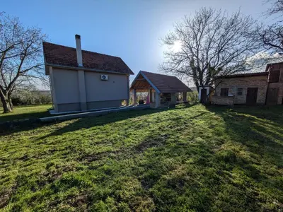 a house with a large yard in front of it at Vila Restart Čortanovci in Čortanovci