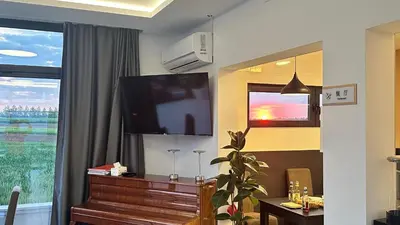 a living room with a flat screen tv and a piano at KIMMIY Garni Attic Rooms near Belgrade Airport in Beograd
