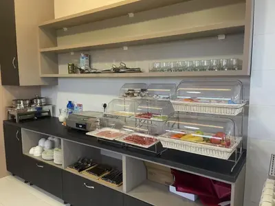 a kitchen with several trays of food on a counter at KIMMIY Garni Attic Rooms near Belgrade Airport in Beograd