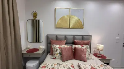 a bedroom with a bed and a desk and a mirror at Luxi TOP in Belgrade