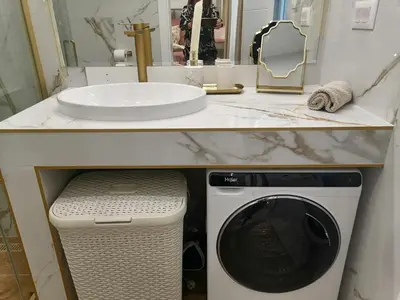 a bathroom with a washing machine under a sink at Luxi TOP in Belgrade