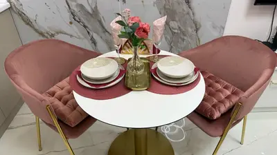 a white table with a vase of flowers on it at Luxi TOP in Belgrade