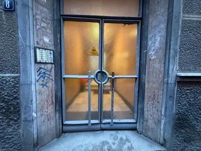a glass door of a building with a sign on it at Luxi TOP in Belgrade