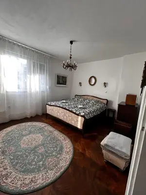 a bedroom with two beds and a rug at Hyde park apartments in Belgrade