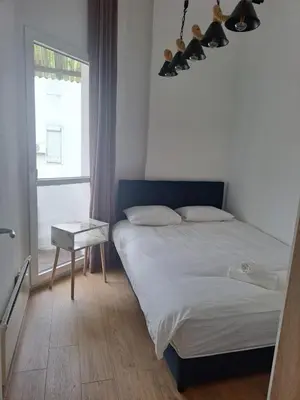 a bedroom with a bed and a window at Mystique apartment Vračar in Belgrade