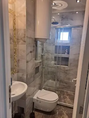 a bathroom with a toilet and a sink and a shower at Mystique apartment Vračar in Belgrade