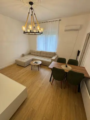 a living room with a couch and a table and chairs at Mystique apartment Vračar in Belgrade