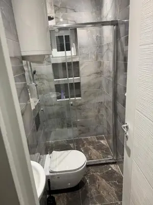 a bathroom with a toilet and a glass shower at Mystique apartment Vračar in Belgrade