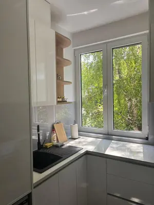 a kitchen with a sink and two windows at Apartment Duchess in Belgrade
