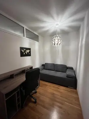 a living room with a couch and a desk at Apartment Duchess in Belgrade