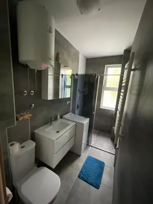 a bathroom with a white toilet and a sink at Apartment Duchess in Belgrade