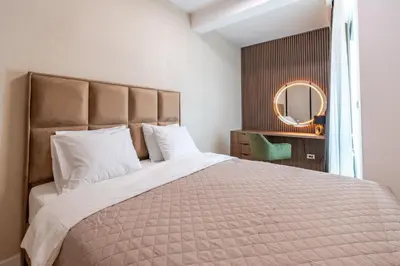 a bedroom with a large bed and a mirror at Park Vila Apartments in Belgrade