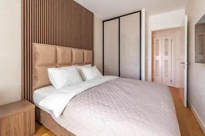 a bedroom with a large white bed with white pillows at Park Vila Apartments in Belgrade