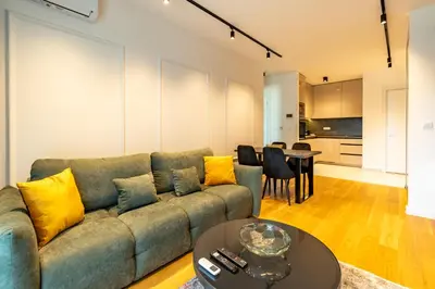 a living room with a couch and a table at Park Vila Apartments in Belgrade