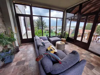 a living room with a couch with a guitar on it at HostelChe Guest House in Smederevo