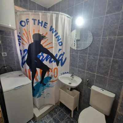 a bathroom with a toilet and a shower curtain at iDoli Stan in Belgrade
