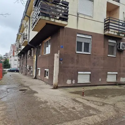 an empty street next to a building with a fire hydrant at iDoli Stan in Belgrade