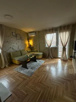 a living room with a couch and a table at Stan na dan Borca in Belgrade