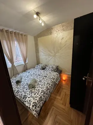 a bedroom with a bed and a window at Stan na dan Borca in Belgrade