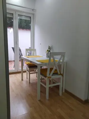 a dining room table with two chairs and a table and a table and chairsktop at Studio apartment near the city center in Belgrade