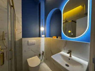 a bathroom with a toilet and a sink and a mirror at Downtown Buzz Mili in Belgrade